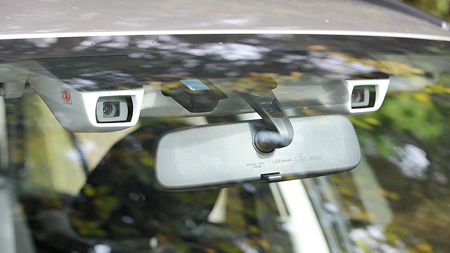 The EyeSight system is mounted to the roof of a vehicle, near the rearview mirror.