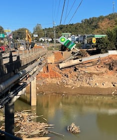 Half the road has fallen into the water and debris is in the river that has now returned to normal levels.