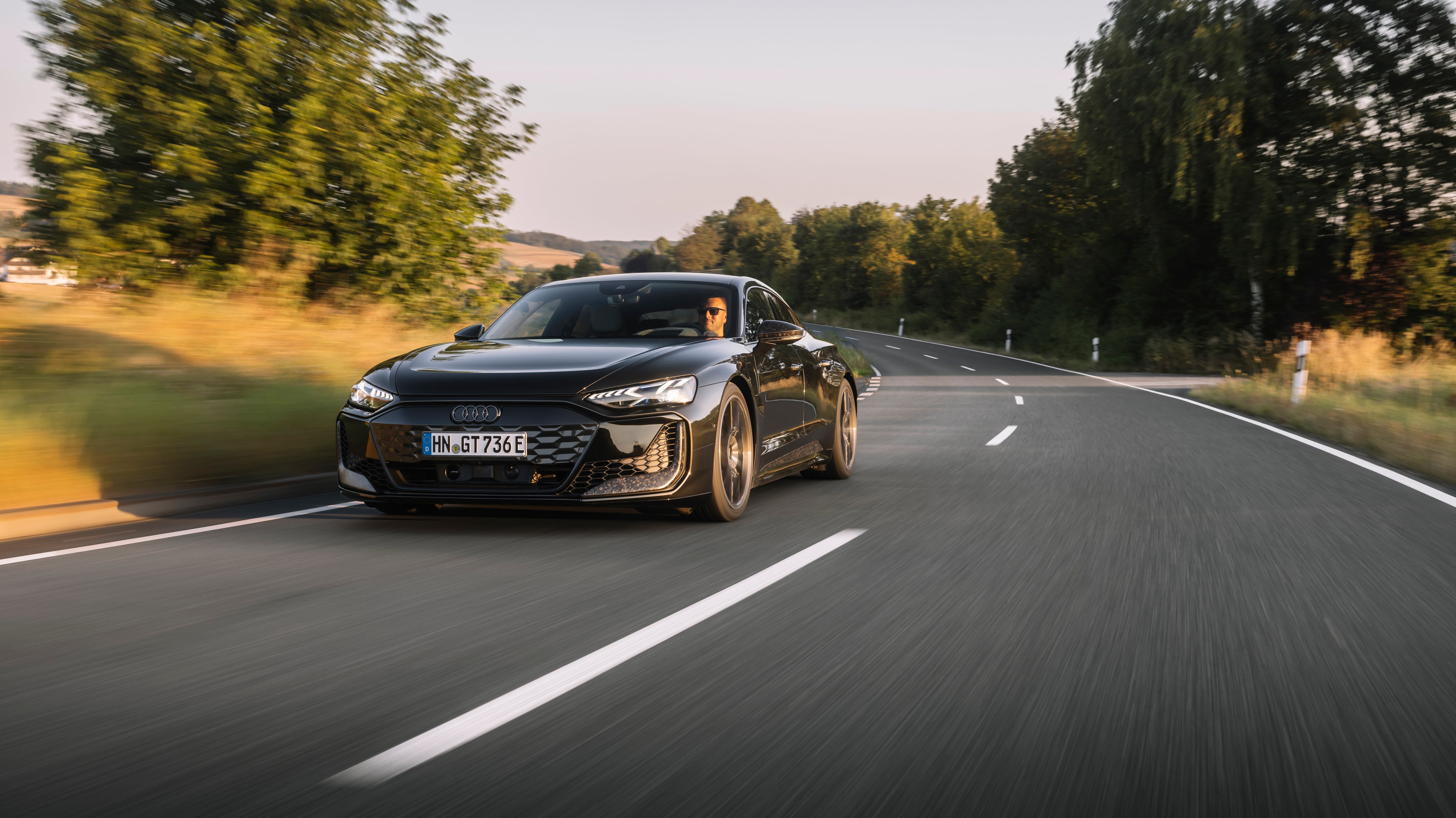 2025 Audi RS e-tron GT performance drives down a road.