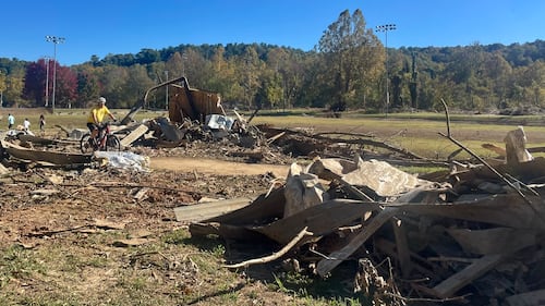 Debris from washed away buildings and trees on the river banks.